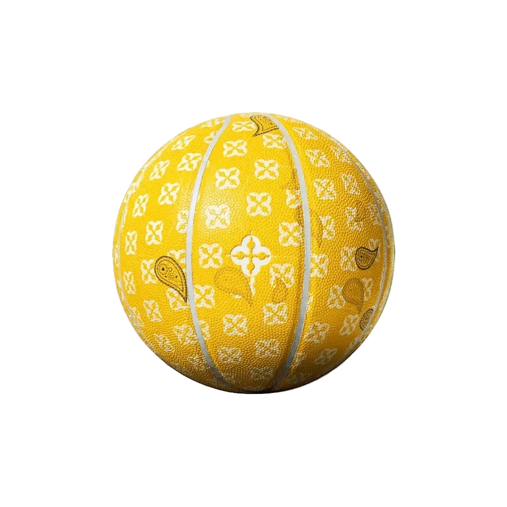 Gele basketbal met monogrampatroon, witte siernaden en gestileerde bloemen
